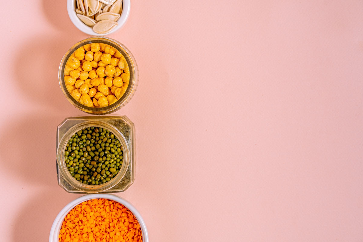 Jars of pumpkin seeds, chickpeas, mung beans and red lentils, everyday plant sources of iron before pregnancy