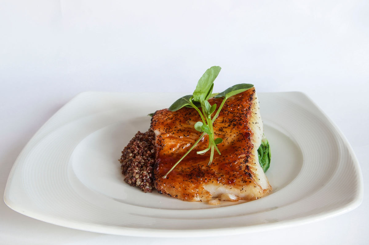 Grilled fish fillet on a white plate, fish being one of the main dietary sources of iodine in the UK