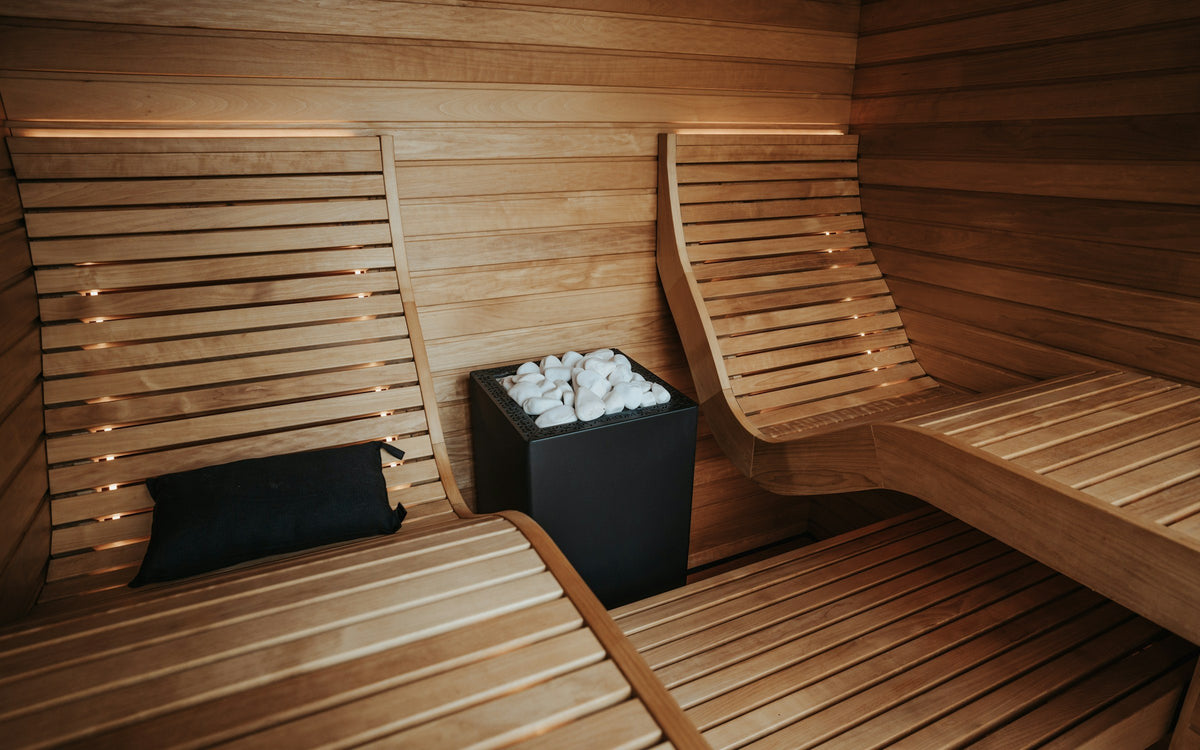 Empty wooden sauna with heated benches and stones, a common source of heat exposure for men