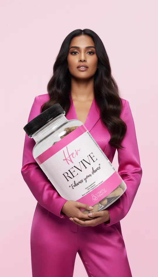 Woman in pink suit holding large bottle of Her Revive fertility and vitality supplements