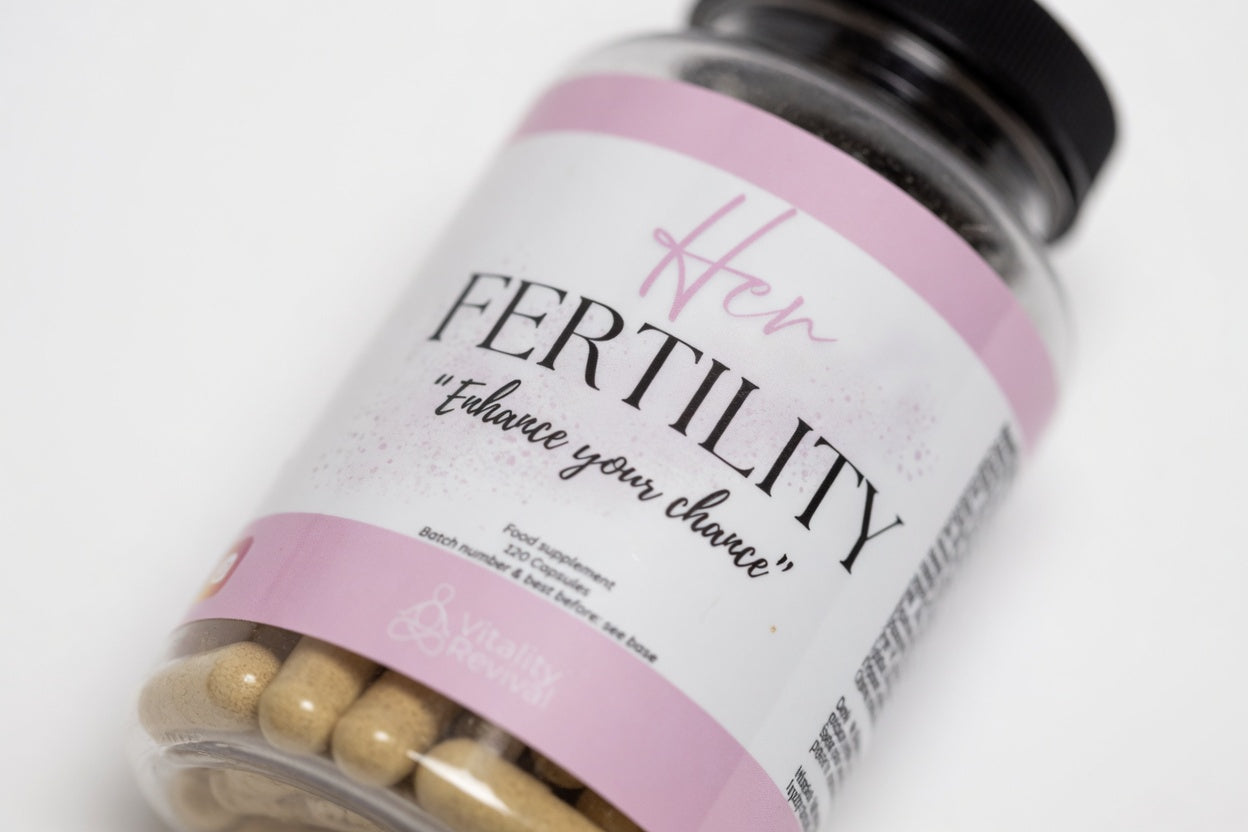 Bottle labeled 'Her Fertility' with pink label and black text on a white background