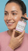 women holding supplement smiling 